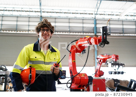 engineer checking control panel and teaching new Automatics robot arm and operating control machine in factory. engineer checking control panel and teaching new Automatics robot arm and operating control machine in factory. 87230945