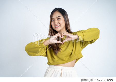 young asian woman smiling in heart shape with fingers 87231699