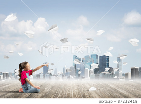 Concept of careless happy childhood with girl pointing with finger at something Concept of careless happy childhood with girl pointing with finger at something 87232418