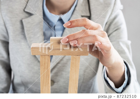 Business woman building tower on table 87232510