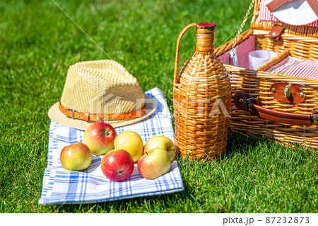 Picnic basket on green sunny lawn in the park 87232873