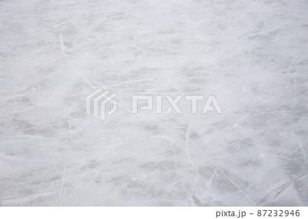 Ice background with marks from skating and hockey, blue texture of rink surface with many scratches Ice background with marks from skating and hockey, blue texture of rink surface with many scratches 87232946