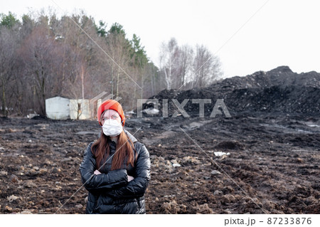 A girl in a protective mask in an apocalyptic world. Environmental disaster. Dangerous toxic zone A girl in a protective mask in an apocalyptic world. Environmental disaster. Dangerous toxic zone 87233876