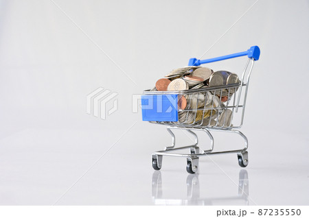 Many coins in the blue shopping cart Isolated on white background and copy space, saving and investment concept 87235550