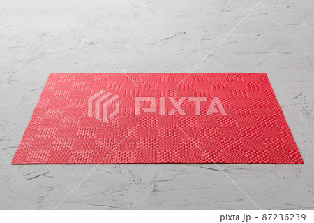 Perspective view of red tablecloth for food on cement background. Empty space for your design 87236239