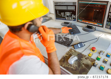 Multiracial worker on his job at construction plant 87237178