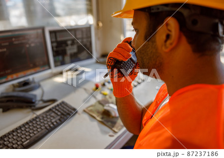 Foreman with safety equipment working at construction plant Foreman with safety equipment working at construction plant 87237186