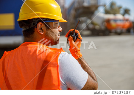 Skillful multiethnic engineer working at industrial plant Skillful multiethnic engineer working at industrial plant 87237187