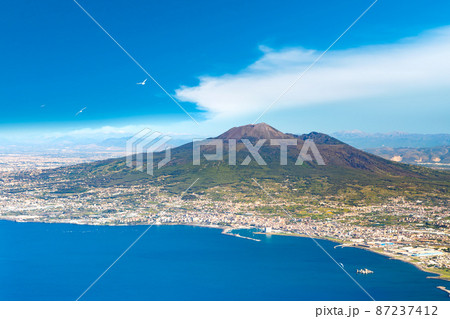 Napoli and mount Vesuvius in the background at sunrise in a summer day, Italy, Campania Napoli and mount Vesuvius in the background at sunrise in a summer day, Italy, Campania 87237412