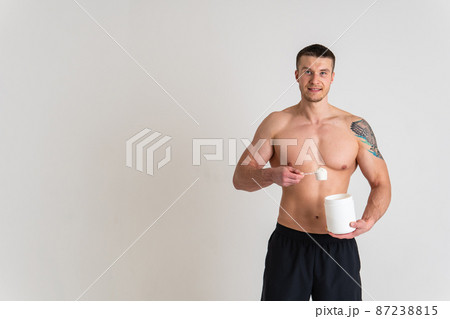 Fitness protein jars white on white background bodybuilder powder strong high back hurt painful, cramp sick man massage stress, holding. Tension red sickness, disease suffer attractive 87238815