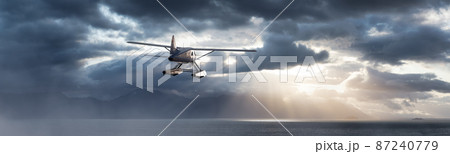 Seaplane Aircraft Flying over the Pacific Ocean Coast 87240779