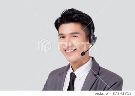 Portrait young asian business man call center wearing headset isolated on white background. Portrait young asian business man call center wearing headset isolated on white background. 87243715