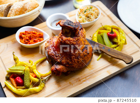 Roasted Ham Hock with pickled vegetables on wooden tray Roasted Ham Hock with pickled vegetables on wooden tray 87245510