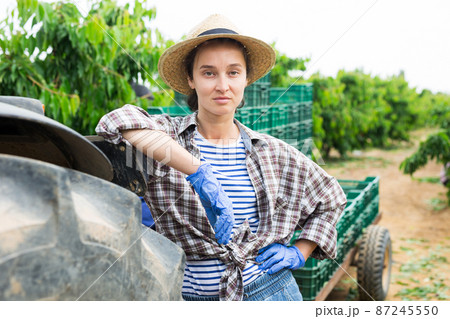 Female gardener with crossed hands posing at garden 87245550