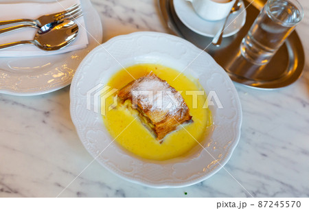 Popular confection is apple strudel with vanilla sauce 87245570