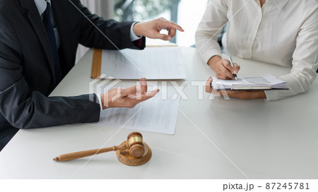 law concept the lawyer partner who wears simple white shirt attempting to catch up and write down from what her boss says 87245781