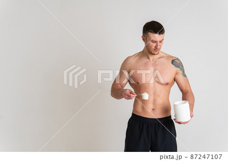 Fitness protein jars white on white background bodybuilder powder strong high pain sore person male young medical, illness holding. Hold neck sickness, lower suffer attractive 87247107