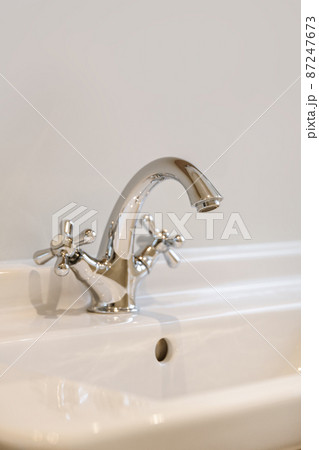 A magnificent comfortable faucet in the sink in an elite bathroom 87247673