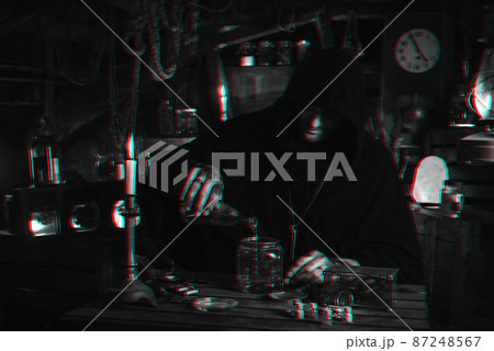 man in alchemist's costume in laboratory with jars by candlelight. Cosplay of computer game character with 3D glitch effect of virtual reality 87248567