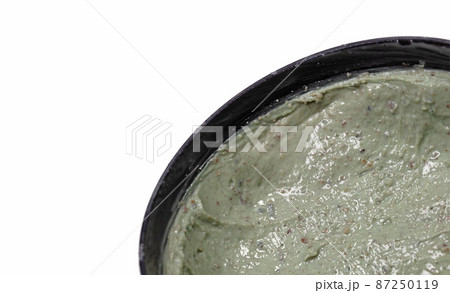Used cup filled with green face mask Used cup filled with green face mask 87250119