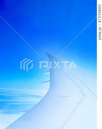 飛行機の窓から見える航空機の羽と空 飛行機の窓から見える航空機の羽と空 87250660