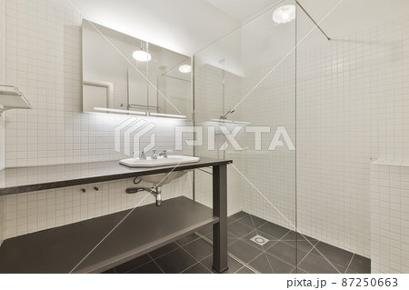 Modern shower stall in a bright bathroom Modern shower stall in a bright bathroom 87250663