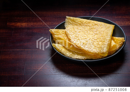 tasty egg pancakes on plate over wooden background tasty egg pancakes on plate over wooden background 87251008