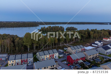 Aerial view of residential houses close to the lake at evening 87253536