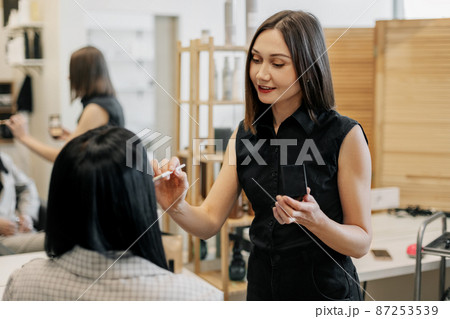 The makeup artist works in her salon, applies professional makeup. Beauty industry, make-up, transformation 87253539