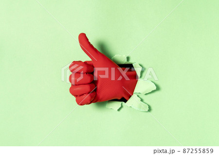 Hand in red rubber glove with thumb up gesture Hand in red rubber glove with thumb up gesture 87255859