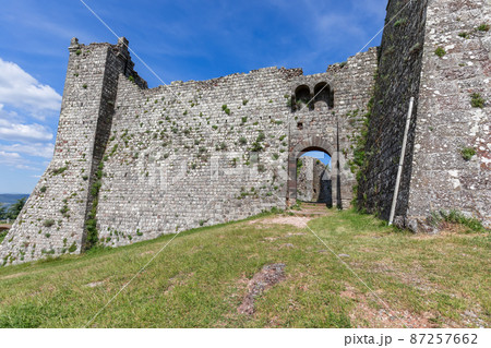 Part of Radicofani fortress remains with a doorway ornament and blue sky background. Tuscany, Italy 87257662