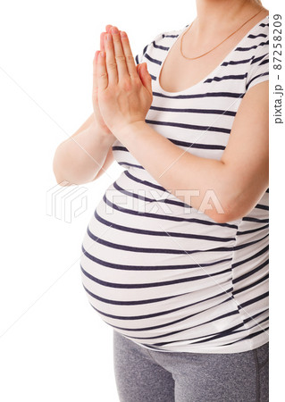 Pregnant woman doing yoga asana asana Tadasana namaste -Mountain pose with salutation Pregnant woman doing yoga asana asana Tadasana namaste -Mountain pose with salutation 87258209