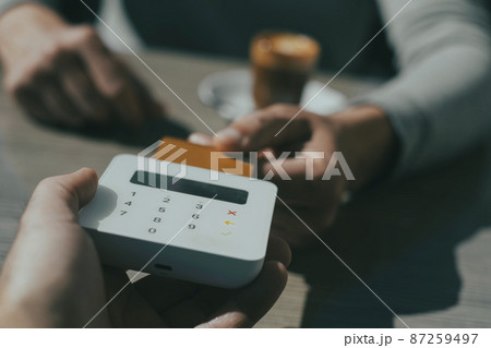 man paying the bill using his credit card man paying the bill using his credit card 87259497