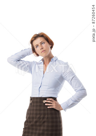 Woman scratching back of head Woman scratching back of head 87260454