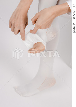 Anti-embolic Compression Hosiery for surgery isolated on white. Medical white stockings, tights for varicose veins and venouse therapy. Thrombo embolic deterrent hose or anti-embolism stockings. Anti-embolic Compression Hosiery for surgery isolated on white. Medical white stockings, tights for varicose veins and venouse therapy. Thrombo embolic deterrent hose or anti-embolism stockings. 87261013