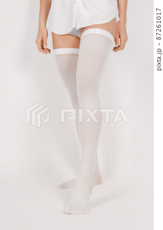 Anti-embolic Compression Hosiery for surgery isolated on white. Medical white stockings, tights for varicose veins and venouse therapy. Thrombo embolic deterrent hose or anti-embolism stockings. Anti-embolic Compression Hosiery for surgery isolated on white. Medical white stockings, tights for varicose veins and venouse therapy. Thrombo embolic deterrent hose or anti-embolism stockings. 87261017