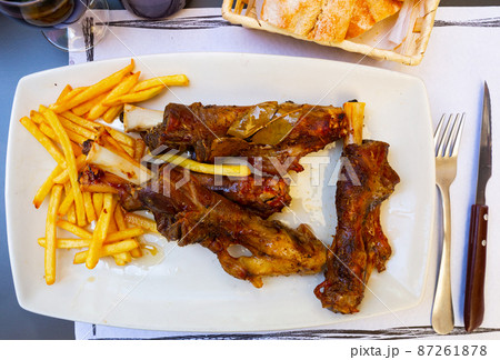 Lamb on the bone with potatoes.  87261878
