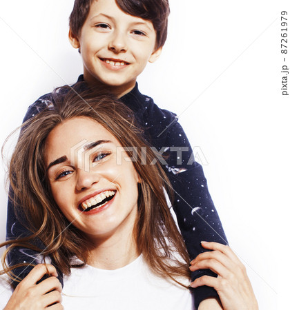 lifestyle and people concept, little cute boy with teenage girl posing together cheerful happy smiling isolated on white background 87261979