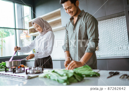 romantic young muslim couple have fun making food at home romantic young muslim couple have fun making food at home 87262642