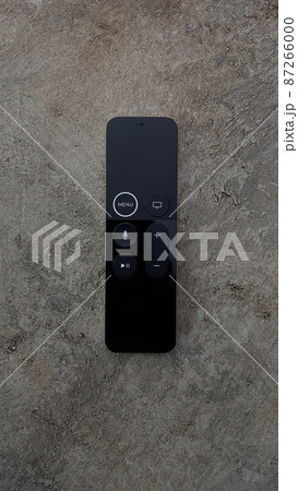 Black remote from the console, on a brown background. Black remote from the console, on a brown background. 87266000