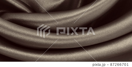 Smooth elegant brown silk or satin texture as abstract background. Luxurious background design. In Sepia toned. Retro style 87266701