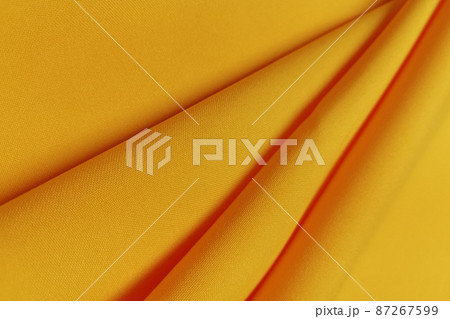 Yellow crumpled or wavy fabric texture background. Abstract linen cloth soft waves. Gabardine wool fabric. Merino yarn. Smooth elegant luxury cloth texture. Concept for banner or advertisement. Yellow crumpled or wavy fabric texture background. Abstract linen cloth soft waves. Gabardine wool fabric. Merino yarn. Smooth elegant luxury cloth texture. Concept for banner or advertisement. 87267599