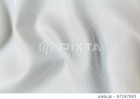 White crumpled or wavy fabric texture background. Abstract linen cloth soft waves. Silk atlas or stretch jacquard. Smooth elegant luxury cloth texture. Concept for banner or advertisement. White crumpled or wavy fabric texture background. Abstract linen cloth soft waves. Silk atlas or stretch jacquard. Smooth elegant luxury cloth texture. Concept for banner or advertisement. 87267605