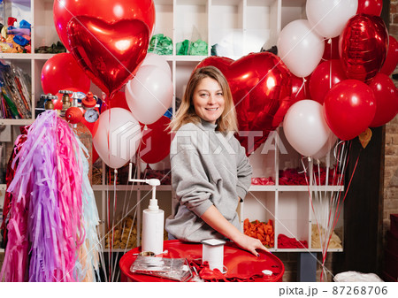 woman with composition of white, red, foil balloons in form of heart and ball. woman with composition of white, red, foil balloons in form of heart and ball. 87268706