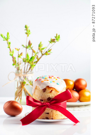 Sweet Easter cake panettone with icing and golden eggs. 87271093