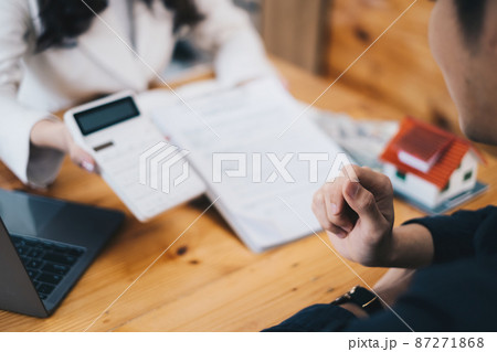 Asian man decide before sign agreement contract and price while broker offer exclusive price. Real Estate concept. Asian man decide before sign agreement contract and price while broker offer exclusive price. Real Estate concept. 87271868