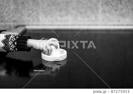 Selective focus on an air hockey table and a small child holding the paddle.  87275053