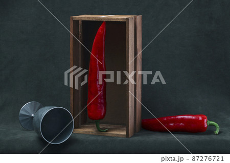 Still life with a glass and red peppers 87276721