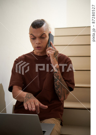 man Discussing Work on Phone man Discussing Work on Phone 87280527