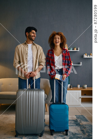 Portrait of happy married couple with suitcases Portrait of happy married couple with suitcases 87280599